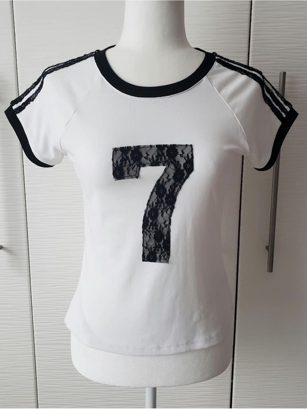 AKIRA White Short Sleeve Tee with Black Lace '7' Applique